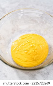 Melted Yellow Chocolate Chips In A Glass Mixing Bowl.