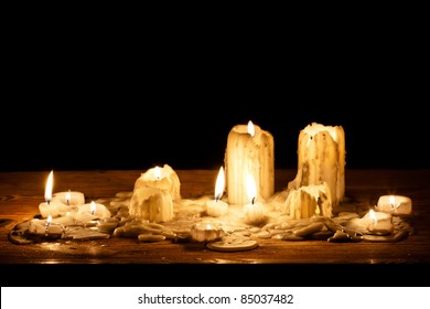 Melting Candle In Wooden Shelf