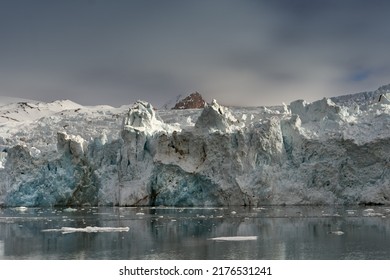 Melting Glacier In Svalbard, Norway. Blue Glacier Ice.