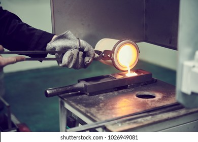 Melting Gold. Molted Metal Pouring Into Bar Form