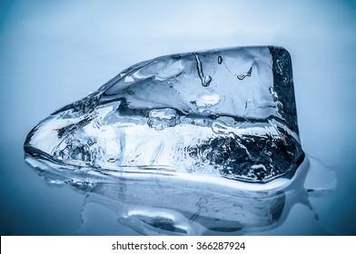 Melting Ice Block On Blue Background