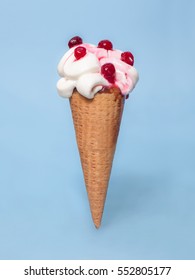 Melting Ice Cream Cone With Cranberries Topping Isolated On Blue Background 