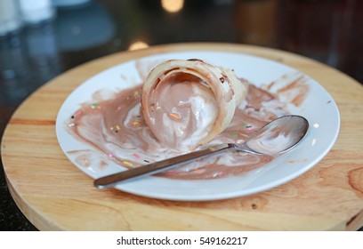 Melting Ice Cream Cone On Dirty Dish