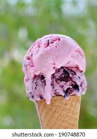 Melting ice cream in cone, strawberry,  blueberry and raspberry flavored.