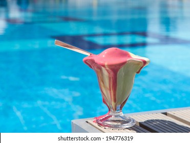 Melting Ice Cream On A Table Near Pool