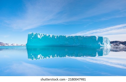 Melting icebergs by the coast of Greenland, on a beautiful summer day - Melting of a iceberg and pouring water into the sea - Greenland - Shutterstock ID 2180047981