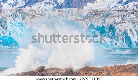 Melting icebergs by the coast of Greenland with strong sea wave - Melting of a iceberg and pouring water into the sea - Greenland  