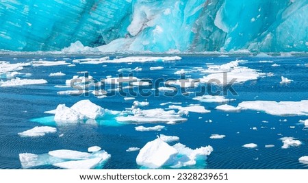 Melting icebergs by the coast of Greenland, on a beautiful summer day - Melting of a iceberg and pouring water into the sea - Greenland