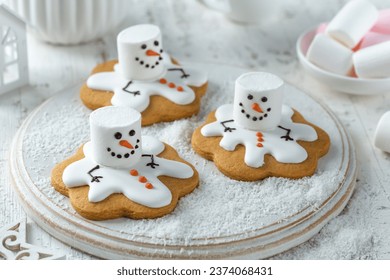 Melting marshmallow snowman cookies. Christmas and New Year dessert and decoration idea for holidays. White background - Powered by Shutterstock