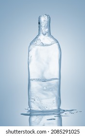 Melting Piece Of Ice In Form Of Glass Bottle. Sculpture, Made Of Clean Ice.