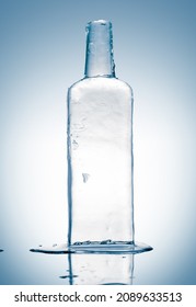 Melting Piece Of Ice In Form Of The Glass Bottle. Sculpture, Made Of Clean Ice. Purity And Freshness Concept.