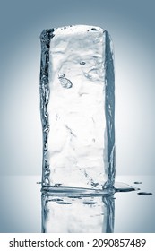 A melting rectangular piece of clean ice, isolated on white background with reflection. Purity concept. - Shutterstock ID 2090857489