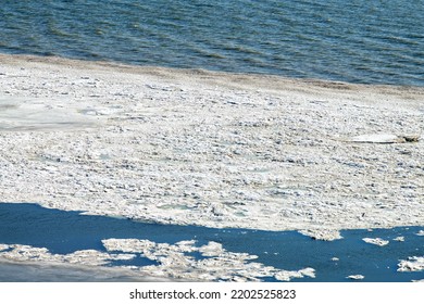 Melting sea ice seasonal natural phenomenon of coming spring, ice on water melts from burning sun. Warm greenhouse effect of weather changing, spring thaw on russian Azov sea