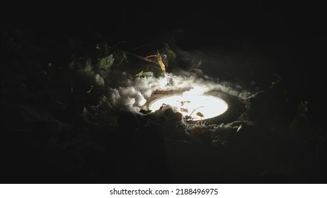 Melting Snow Creating Vaporizing Water Mist Over Bright Hot Outdoor Pavement Lamp