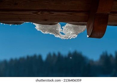 Melting Snow Dripping From Rooftop