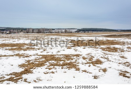 The melting of the snow on the fields in early spring
