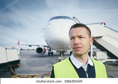 Member Ground Crew Worker At The Airport In Front Of The Airplane. 