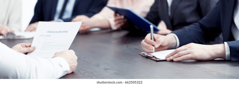 Member of management making notes of candidate's CV during interview