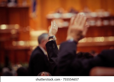 Member Of Romanian Parliament Is Voting By Raising His Hand