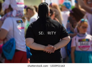 Member of security guard team on public event. The word "security" on the back of a security guard's.