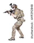 Member of US Army rangers in combat uniforms with his shirt sleeves rolled up, in helmet, eyewear and night vision goggles, ready to firing. Low readiness position. Studio shot, white background