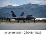 Members of the Air Combat Command F-22 Raptor Demonstration Team prepare to launch a jet during a demonstration at Joint Base Elmendorf-Richardson, Alaska