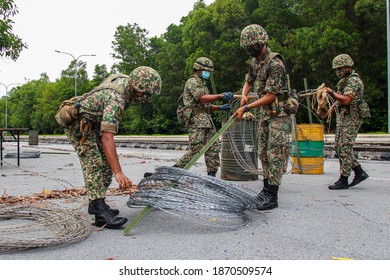 Members Of Malaysian Armed Forces Are Open The Barbed Wire Following Enhanced Movement Control Order In Nilai, Negeri Sembilan, Malaysia On December 1, 2020