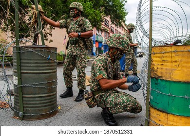 Members Of Malaysian Armed Forces Are Open The Barbed Wire Following Enhanced Movement Control Order In Nilai, Negeri Sembilan, Malaysia On December 1, 2020