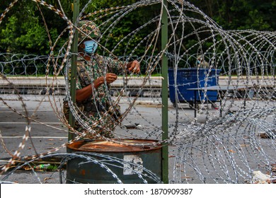 Members Of Malaysian Armed Forces Are Open The Barbed Wire Following Enhanced Movement Control Order In Nilai, Negeri Sembilan, Malaysia On December 1, 2020