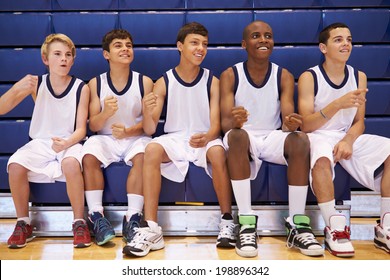 Members Of Male High School Basketball Team Watching Match