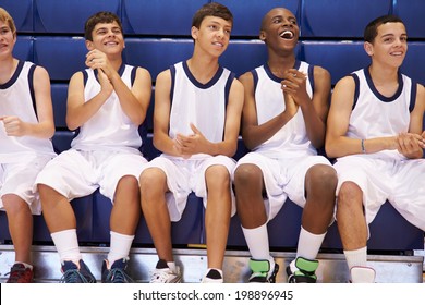 Members Of Male High School Basketball Team Watching Match