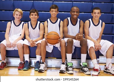 Members Of Male High School Basketball Team On Bench