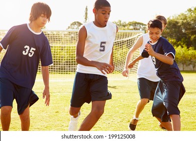 Members Of Male High School Soccer Playing Match - Powered by Shutterstock