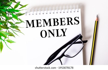 MEMBERS ONLY Is Written In A White Notebook Next To A Pencil, Black-framed Glasses And A Green Plant