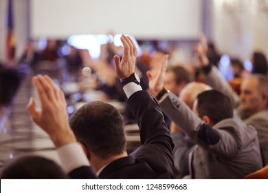 Members of Romanian Parliament vote by raising their hands - Shutterstock ID 1248599668