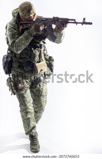 Members of the Special Forces unit. Russian\
Special Operations fighter with AK-74 assault rifle\
aiming a\
machine gun on a white\
background