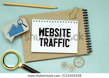 Memo note written with text WEBSITE TRAFFIC isolated on green background