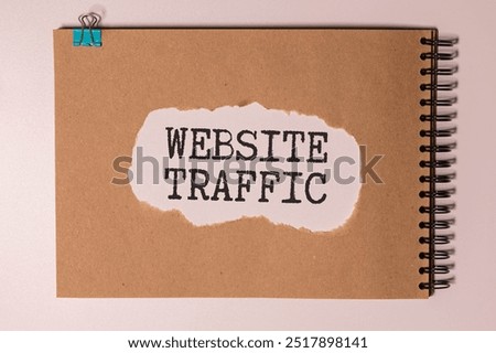 Memo note written with text WEBSITE TRAFFIC isolated on green background.