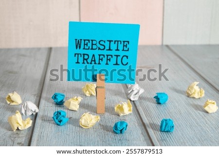 Memo note written with text WEBSITE TRAFFIC isolated on green background