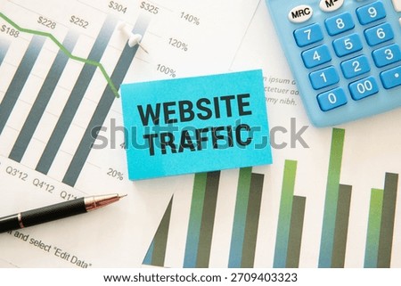 Memo note written with text WEBSITE TRAFFIC isolated on green background.