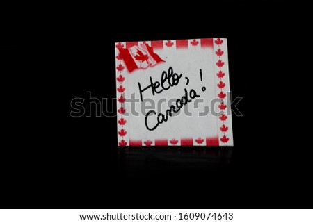 Memo post reminder with text Hello, Canada. Writing on paper with Canada flag. Bucharest, Romania, 2020.