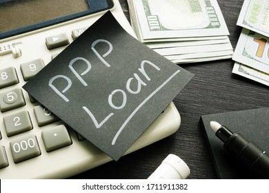 Memo sign PPP Loan Paycheck Protection Program on the black piece of paper.