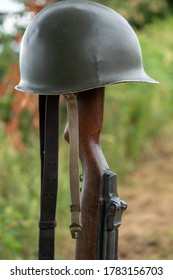 Memorial Battlefield Cross. The Symbol Of A Fallen US Soldier. M1 Rifle With Helmet.