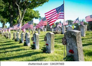Memorial Day American flags and military grave marker at military cemetery honoring those who sacrificed all in service to their country