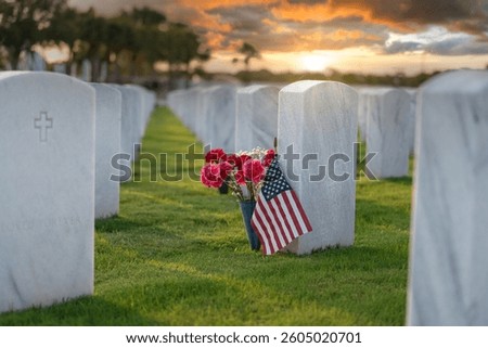 Memorial Day concept. Sarasota National Cemetery with rows of white tomb stones with USA flags and flowers