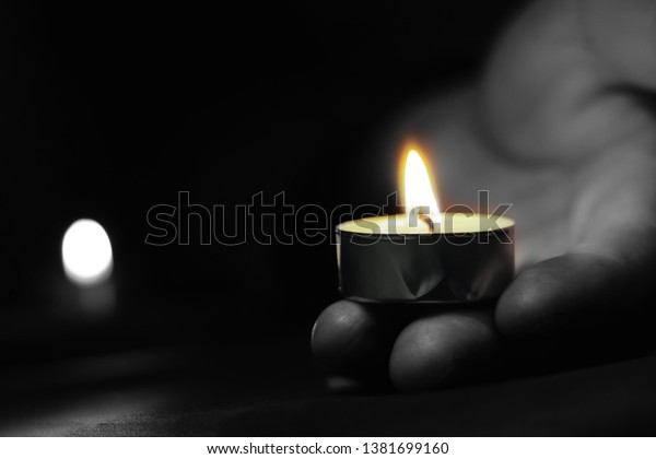 Memorial Day International\
Holocaust Remembrance Day The hand holds a candle on the day of\
remembrance.