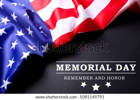 Memorial day weekend text written black chalkboard background with USA flag. United States of America stars & stripes patriot veteran remembrance symbol. Close up, copy space, top view.