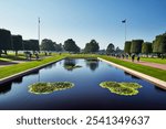 A memorial pool with flags at the Normandy American Cemetery in France