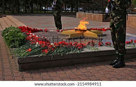 memorial to the unknown soldier of the Russian army with an eternal flame, flowers, guard of honor