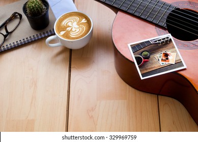 Memories Of Music Travel Stuff And Cup Of Coffee Latte Art On Wooden Table,vintage Tone In Photo.